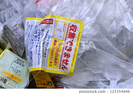 Yokohama cityscape, Japan: A "No collection" sticker left on plastic containers and packaging on collection day...garbage collection area 125354846