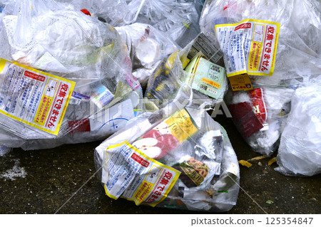 Yokohama cityscape, Japan: A "No collection" sticker left on plastic containers and packaging on collection day...garbage collection area Yokohama cityscape, Japan: A "No collection" sticker left on plastic containers and packaging on collection day...garbage collection area 125354847