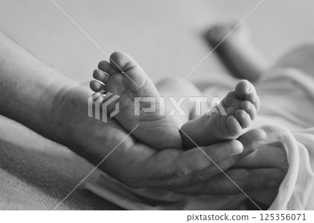 A newborn baby is wrapped in diapers with a wool cap in a basket. Swaddling, maternity hospital, family, ivf, life planning, parenting. A mother's love for her child. Baby food. High quality photo 125356071
