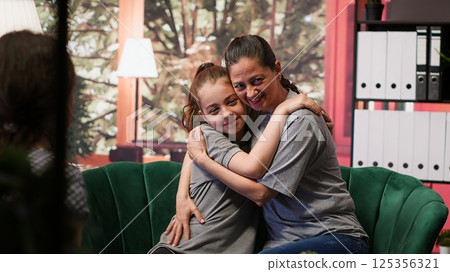 Sweet supportive mom showing acceptance for her teenage daughter, showing compassion and unconditional love with a hug. Mother accepting her girl with hormonal shifts, family relations. Camera A. 125356321