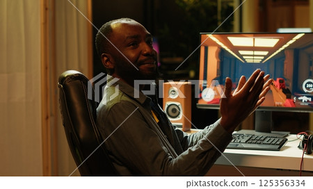 Pro gamer arriving in studio, starting stream teaching subscribers strategies to beat foes during livestream. Man recording videogames esports guide for internet audience, camera A 125356334