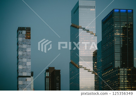 A collection of tall buildings featuring stairs that connect them all 125356349