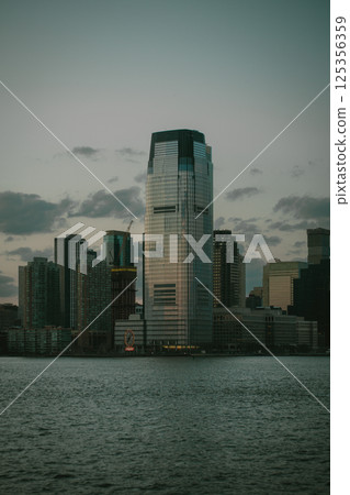 A stunning skyline with skyscrapers and a large body of water 125356359