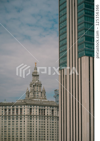 A tall domed building is surrounded by other tall buildings 125356366