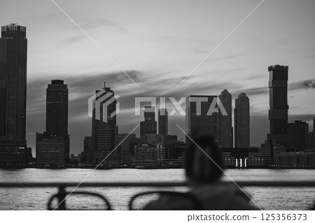 A beautiful black and white photo of a city skyline taken from a boat 125356373