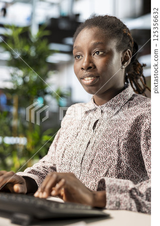 Businesswoman analyzing performance metrics on her computer at the workplace, office life. Engaged in strategic planning, she reviews data to support company objectives for successful outcomes. Businesswoman analyzing performance metrics on her computer at the workplace, office life. Engaged in strategic planning, she reviews data to support company objectives for successful outcomes. 125356632
