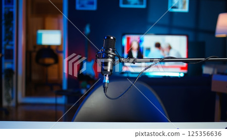 Close up shot of professional streaming microphone in empty neon lit studio used for online video content production. Panning shot of content creation recording mic in apartment Close up shot of professional streaming microphone in empty neon lit studio used for online video content production. Panning shot of content creation recording mic in apartment 125356636