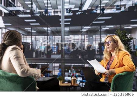 Female CEOs and managers discussing data management and business strategies using their influence and resilience for achieve greatness in a men dominated environment. Corporate feminism. Female CEOs and managers discussing data management and business strategies using their influence and resilience for achieve greatness in a men dominated environment. Corporate feminism. 125356909