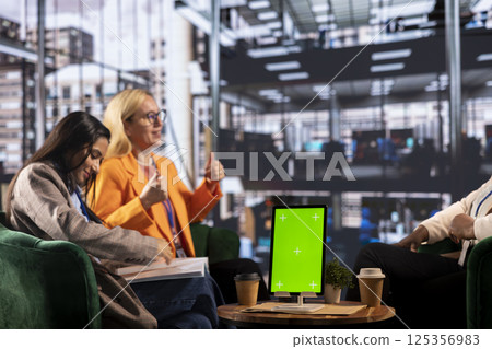 Group of diverse colleagues sharing ideas to achieve greatness in a men dominated business industry, using an isolated chroma key screen. Female leaders working together for a success story. 125356983