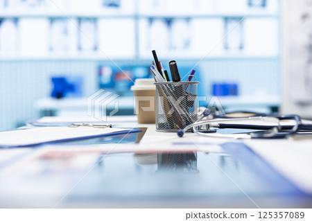 Empty medical cabinet equipped with modern equipment designed to help in finding the right diagnostic, x ray machine and hospital records. Private clinic office space for healthcare industry. Empty medical cabinet equipped with modern equipment designed to help in finding the right diagnostic, x ray machine and hospital records. Private clinic office space for healthcare industry. 125357089