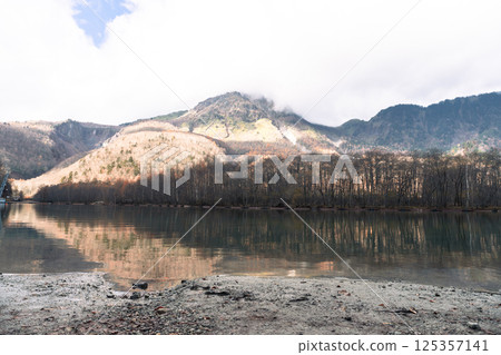 Clear Azusa river water and pine trees in Kamikochi national park in autumn season 125357141