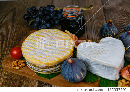 Selection of French cheeses from Normandy, AOP, Livarot, Neufchatel, Pont l'eveque, Rye bread, figs 125357591