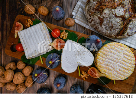 Selection of French cheeses from Normandy, AOP, Livarot, Neufchatel, Pont l'eveque, Rye bread, figs 125357618