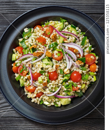 Barley salad with vegetables and walnuts in a bowl 125358115