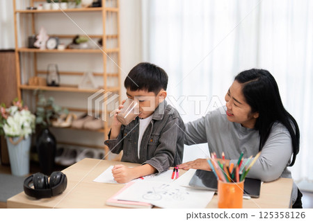 Back to School and Family Bonding. A mother and son preparing for school, sharing moments of joy and learning together. 125358126