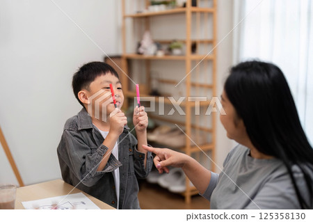 Back to School and Creative Play. A boy engaging in fun activities with his mother. 125358130