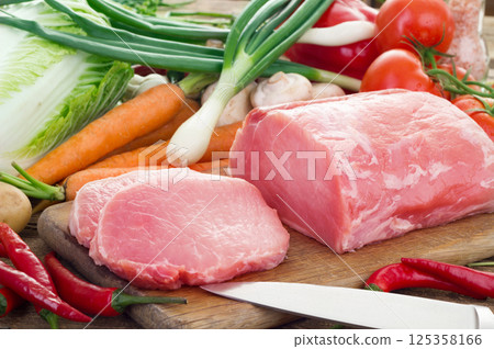 Vegetables and pork meat on cutting board 125358166