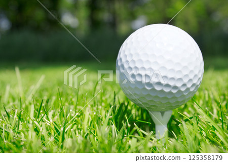 Golf ball on tee 125358179