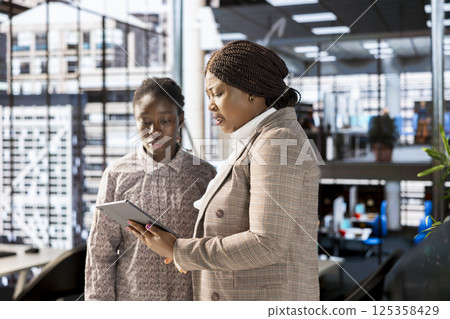 African American team collaborates on a financial planning project in a corporate office, emphasizing teamwork and data analysis to make informed decisions for future firm growth. African American team collaborates on a financial planning project in a corporate office, emphasizing teamwork and data analysis to make informed decisions for future firm growth. 125358429
