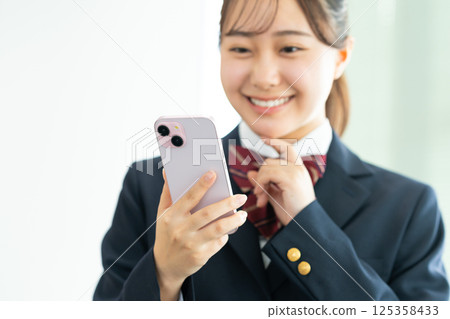 High school girl using a smartphone. Photo courtesy of Denpa Gakuen, Tokyo Electronics College. High school girl using a smartphone. Photo courtesy of Denpa Gakuen, Tokyo Electronics College. 125358433