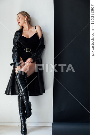 Fashionable slim woman in black clothes and makeup 125358907