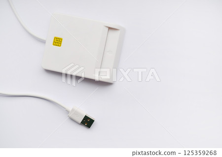 Close-up of a smart card reader with USB cable on a white background Close-up of a smart card reader with USB cable on a white background 125359268