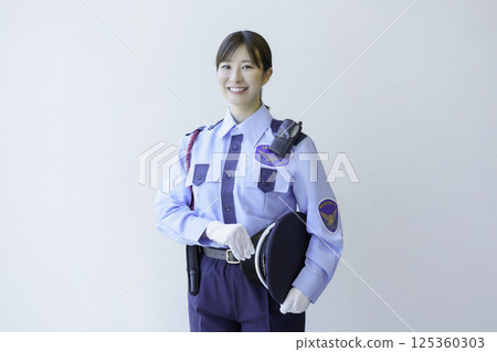 Portrait of a young female security guard against a white background. Photo courtesy of Denpa Gakuen Tokyo Electronics College. 125360303