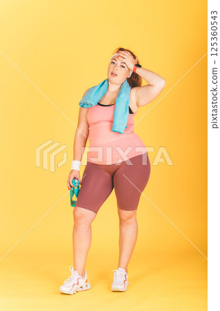 A woman in a pink tank top 125360543