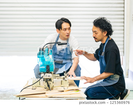 A man learning how to use an electric saw - DIY A man learning how to use an electric saw - DIY 125360976