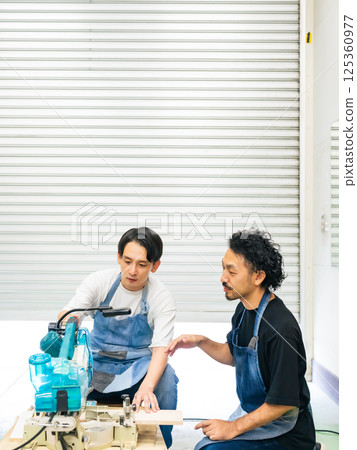 A man learning how to use an electric saw - DIY A man learning how to use an electric saw - DIY 125360977