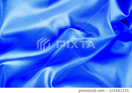 Light blue color silk in soft, smooth waves with a glossy finish. Suitable for design and wallpaper background. Light blue color silk in soft, smooth waves with a glossy finish. Suitable for design and wallpaper background. 125361335