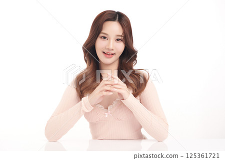 A beautiful young Asian woman with clean, fresh skin against a white background. Skincare, facial treatment, cosmetology, beauty, and spa. An elegant portrait of an Asian woman. A beautiful young Asian woman with clean, fresh skin against a white background. Skincare, facial treatment, cosmetology, beauty, and spa. An elegant portrait of an Asian woman. 125361721