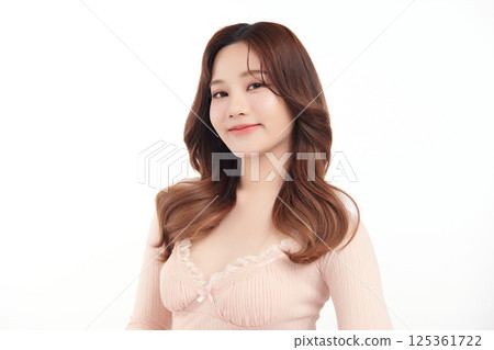 A beautiful young Asian woman with clean, fresh skin against a white background. Skincare, facial treatment, cosmetology, beauty, and spa. An elegant portrait of an Asian woman. A beautiful young Asian woman with clean, fresh skin against a white background. Skincare, facial treatment, cosmetology, beauty, and spa. An elegant portrait of an Asian woman. 125361722
