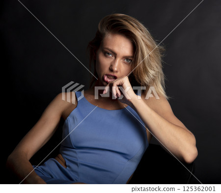portrait of a young beautiful woman on a dark background portrait of a young beautiful woman on a dark background 125362001