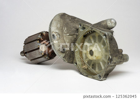 car windshield wipers motor, disassembled, plastic ring gear in dirty gear housing, in grease, armature. selective focus 125362045
