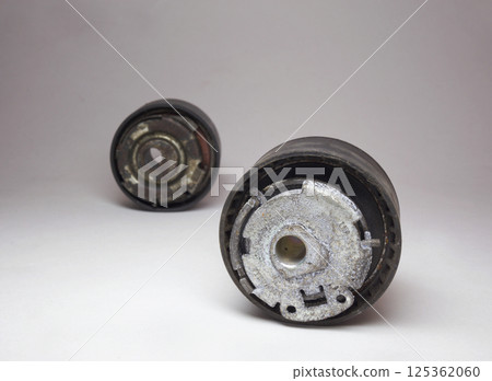 timing belt tensioner roller closeup, and second roller out of focus in background 125362060