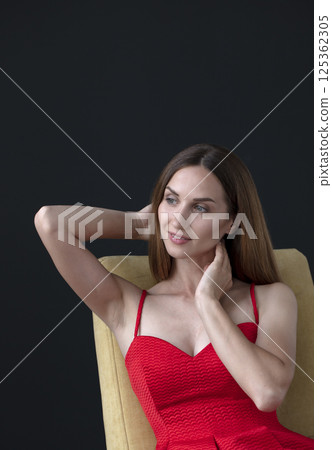 studio portrait on a dark background of a beautiful young woman 125362305
