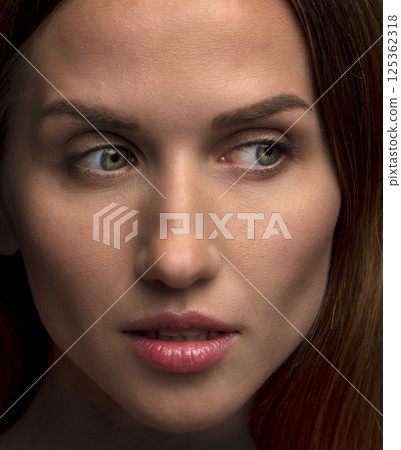 studio portrait on a dark background of a beautiful young woman studio portrait on a dark background of a beautiful young woman 125362318