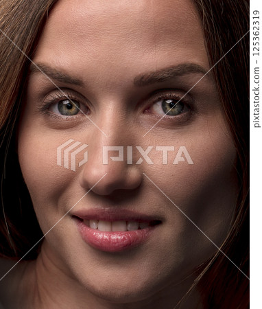 studio portrait on a dark background of a beautiful young woman studio portrait on a dark background of a beautiful young woman 125362319