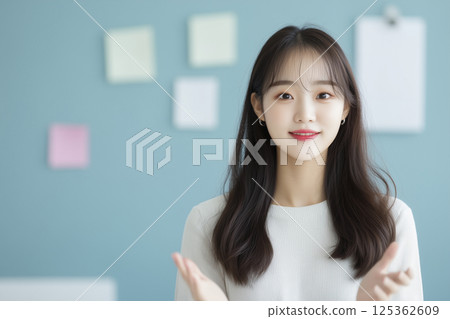 Woman with long hair and a white shirt is smiling 125362609