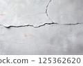 Crack in a wall with a white background 125362620