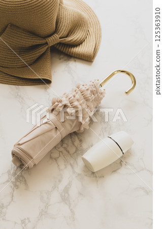 Folding parasol and sunscreen: Image of protection against UV rays in summer 125363910