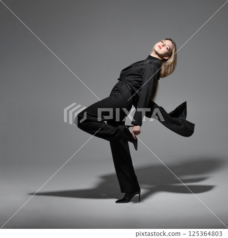 Beautiful woman with tailcoat studio portrait 125364803