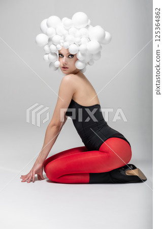 Avant-Garde Fashion Pose with Balloon Headdress 125364862