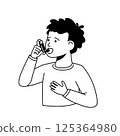A boy treats his asthma with an inhaler. 125364980