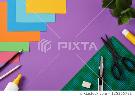Paper craft supplies: scissors, craft knife, pencil, eraser, cutting mat, paper. Space for text. Paper craft supplies: scissors, craft knife, pencil, eraser, cutting mat, paper. Space for text. 125365751