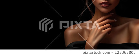 Close-up of sensual woman with glossy lips and flawless skin, dark background beauty portrait. 125365803