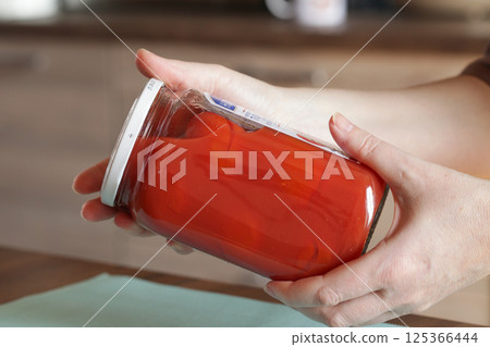 Glass Jar of pickled tomatoes with lid with expiration date 125366444