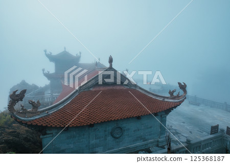 Temple foggy in mysterious mountain at Fansipan, Vietnam Temple foggy in mysterious mountain at Fansipan, Vietnam 125368187