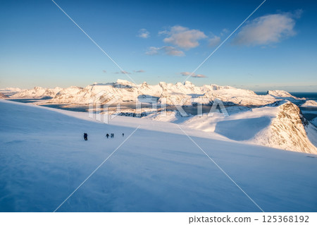 Group of mountaineer hiking on snow covered mountain at Norway 125368192